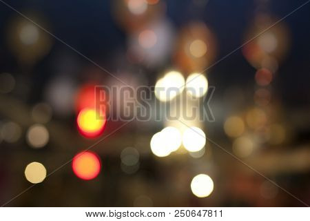 Many Blurred Small Electric Bulbs. A Blurry Photo Of The City