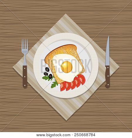 Plate With Fried Egg, Toast And Tomatoes On A Wooden Background. There Is Also A Fork And A Knife In