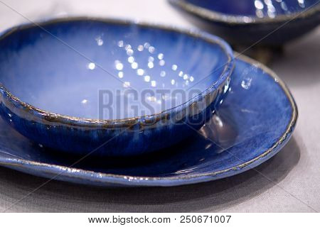 Blue Porcelain Plates And Bowls On The Table
