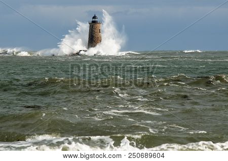 Giant Waves Surround Stone Lighthouse Tower Of Whalback Light In Maine During A Unique High Tide.