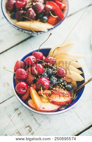 Healthy Breakfast Smoothie Bowl With Fresh Fruit And Berries, Bee Pollen And Honey On Blue Table Bac