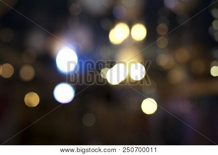 Many Blurred Small Electric Bulbs. A Blurry Photo Of The City