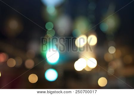 Many Blurred Small Electric Bulbs. A Blurry Photo Of The City