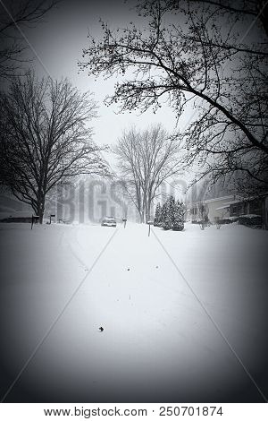 A Black And White Picture Of A Snow Covered Road