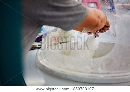 Hand Rolling Cotton Candy In Candy Floss Machine. Making Candy Floss