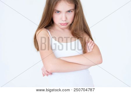 Emotion Face. Child Making A Hurt Look. Offended Capricious Kid With Her Arms Crossed. Little Girl P