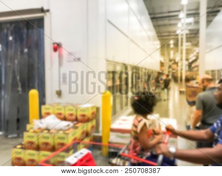 Customer Shopping In Wholesale Store Near Cold Storage Room