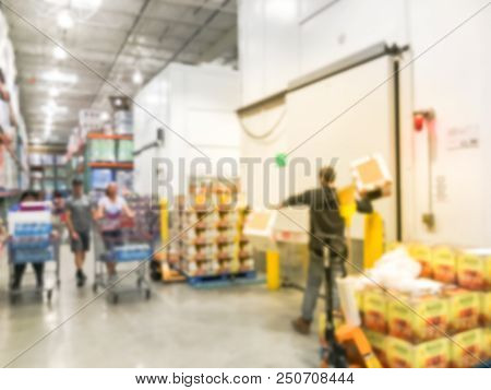 Worker With Manual Forklift Stockpile Goods Near Cold Storage Room In Wholesale Store