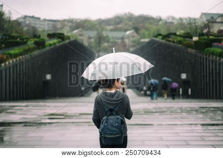 Young Asian Woman Traveler In Lonely Feeling Holding Umbrella Traveling In Ewha Womans University At