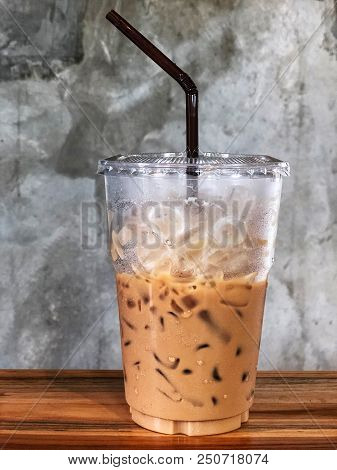 Ice Coffee In Plastic Cup And Brown Tube On The Wooden Table, Relaxing And Freshy, Vintage Style And