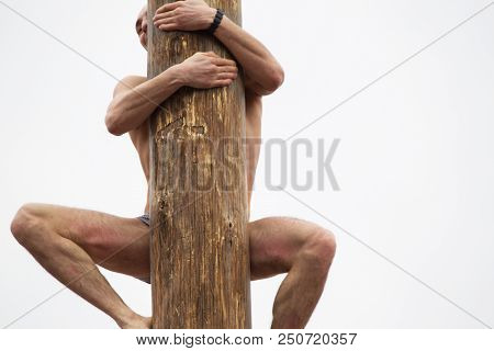 Belarus, Gomel, On March 12, 2016. Central Square. Celebration Of Carnival. The Man Climbs On The Pi