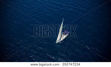 Sailing boat on open water, aerial view. Active life style, water transportation and marine sport.