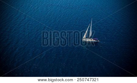 Sailing boat on open water, aerial view. Active life style, water transportation and marine sport.