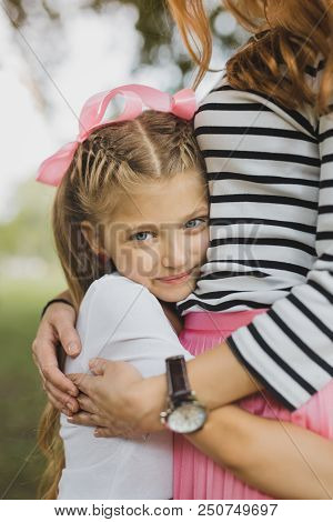 Appealing Daughter. Blonde-haired Blue-eyed Appealing Daughter Feeling Protected While Hugging Her P