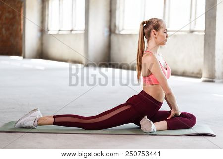 Stretching After Great Workout. Young Beautiful Gym Woman In Sportswear Doing Stretching While Stand
