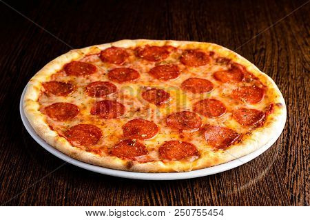 Delicious Hot Homemade Pepperoni Pizza On The Wooden Table