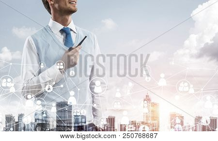 Double Exposure Of Confident And Young Businessman In Smart-casual Wear Smoking Pipe And Modern City