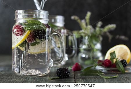 A Cooling Lemon Drink In A Glass Cup On A Wooden Table