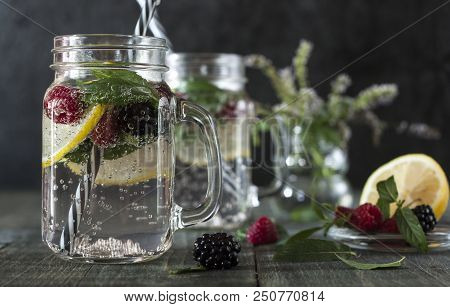 A Cooling Lemon Drink In A Glass Cup On A Wooden Table