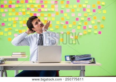 Man in the office with many conflicting priorities doing exercis