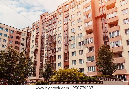 New Multi-storey Residential Building With Car Parked In Front. Modern Archicture