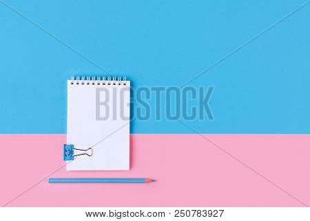 Top View Of Blank Notebook On Colorful Background Pink Blue With Copy Space.