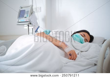 Close Up Young Woman Patient Lay On Bed In Hospital With Intravenous Normal Saline