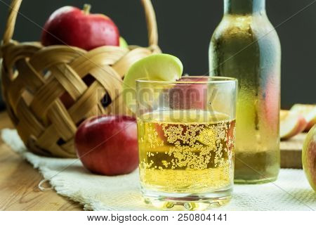 Close-up Image Of Sparkling Cidre Drink And Ripe Juicy Apples On Rustic Wooden Table. Glass Of Home 