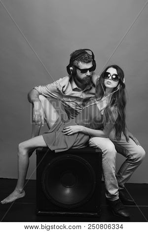 Man With Beard Wears Headphones And Sunglasses. Technologies And Music Concept. Couple In Love Lies 