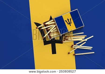 Barbados Flag  Is Shown On An Open Matchbox, From Which Several Matches Fall And Lies On A Large Fla
