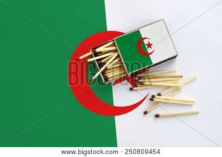 Algeria Flag  Is Shown On An Open Matchbox, From Which Several Matches Fall And Lies On A Large Flag