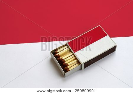 Indonesia Flag  Is Shown In An Open Matchbox, Which Is Filled With Matches And Lies On A Large Flag.