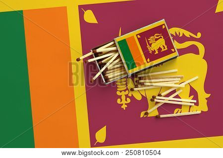 Sri Lanka Flag  Is Shown On An Open Matchbox, From Which Several Matches Fall And Lies On A Large Fl