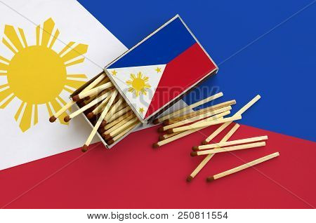 Philippines Flag  Is Shown On An Open Matchbox, From Which Several Matches Fall And Lies On A Large 