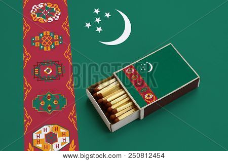 Turkmenistan Flag  Is Shown In An Open Matchbox, Which Is Filled With Matches And Lies On A Large Fl