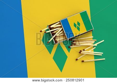 Saint Vincent And The Grenadines Flag  Is Shown On An Open Matchbox, From Which Several Matches Fall
