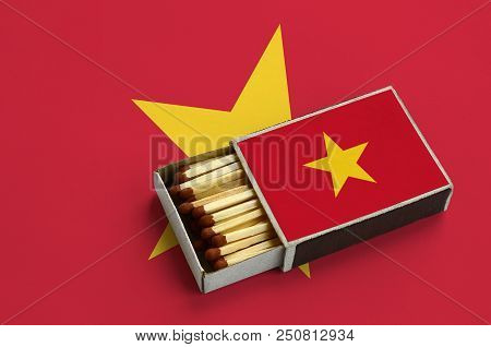 Vietnam Flag  Is Shown In An Open Matchbox, Which Is Filled With Matches And Lies On A Large Flag.