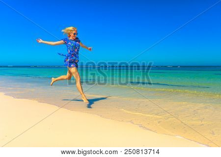 Beach Freedom Summer Vacation. Joyful Happy Woman Jumping On Seashore Of White Sand In Popolar Hango