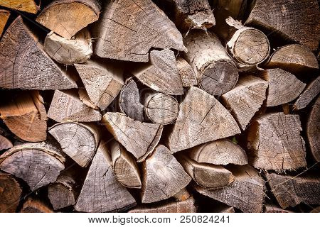 Firewood Neatly Stacked. Background With Texture Of Wood.
