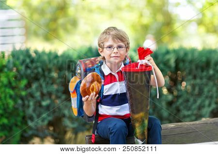 Happy Little Kid Boy With Glasses And Backpack Or Satchel On His First Day To School . Child Outdoor