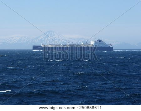 Kamchatka.Kamchatsky kray / Russia - July 10 2018: LNG tanker Eduard Toll sailing on the background of Kamchatka volcanoes