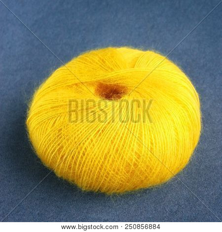 Yellow Yarn Ball Of Mohair (angora) Wool For Knitting On The Velvet Background. Front View.