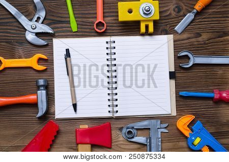 Blank Page Notepad And Different Building Construction Toy Tools. Construction Background With Copy 