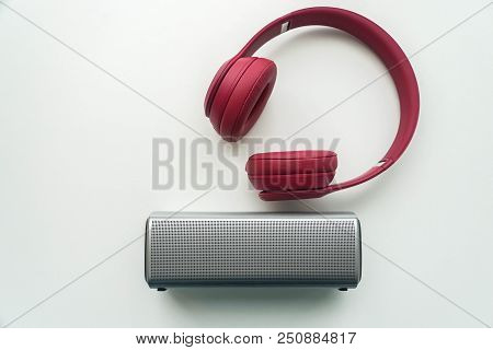 Flat Lay Isolated Wireless Portable Speaker With Pink Bluetooth Headphones For Music Listening