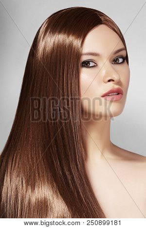 Beautiful Yong Woman With Long Straight Brown Hair. Sexy Fashion Model With Smooth Gloss Hairstyle.