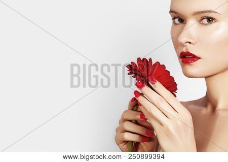 Close-up Beauty Portrait Sexy Woman With Red Lips, Lipstick And Beautiful Red Flower. Spa Clean Skin