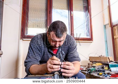 Sculptor Is Giving Stance, Attitude To His Figures Made Of Metal Wire In His Workshop.