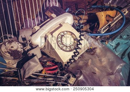 Old Telephone With Rotary Dial And Other Junk Yard