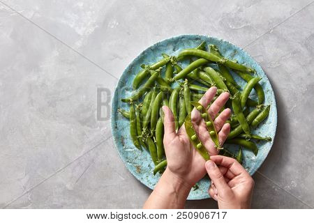 Pear sticks on blue ceramic plate on gray concrete table stick of pea, which cleans or opens the female hand. Flat lay.