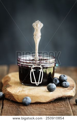 Homemade Blueberry Preserves In A Canning Glass Bail Jar With Antique Spoon. Extreme Shallow Depth O